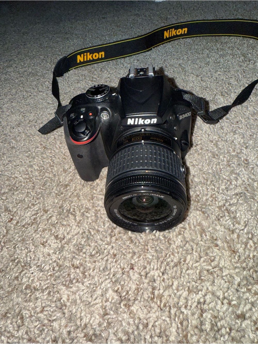Nikon Black DSLR with Zoom Lens and Branded Neck Strap